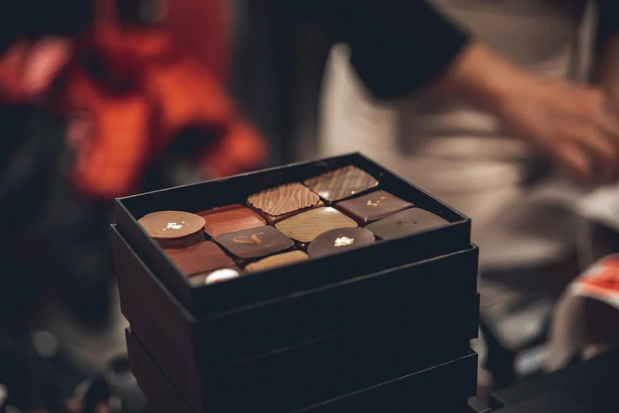 Elegant box of assorted aphrodisiac chocolates in warm ambient lighting — UK buyer's guide