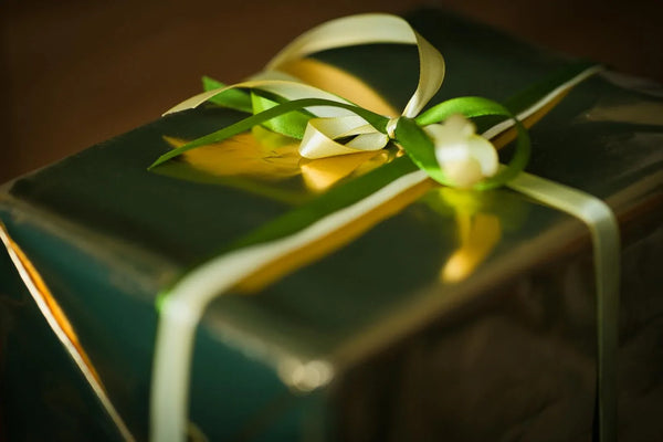 Wrapped Christmas gift with green paper and a ribbon
