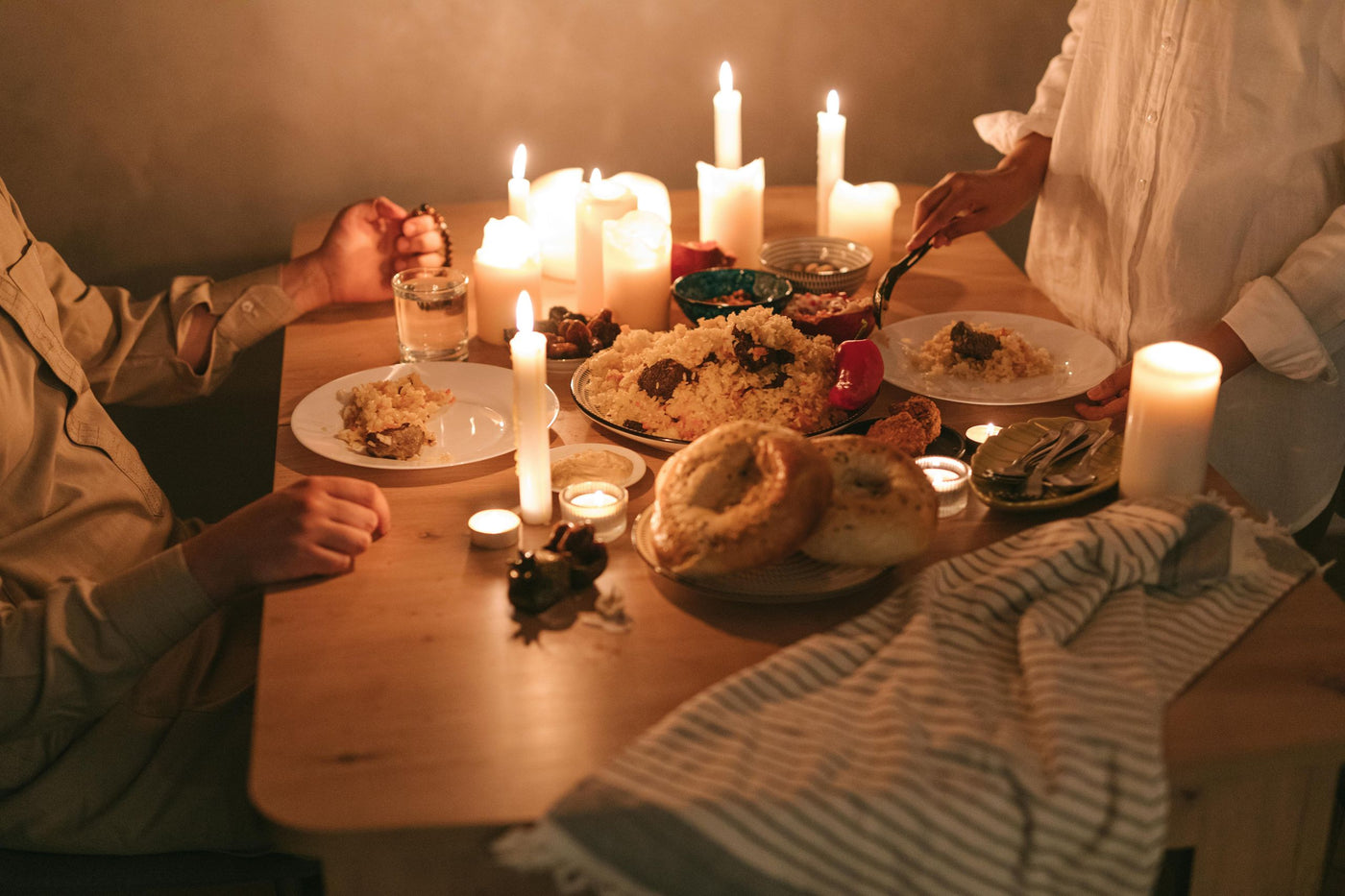 Couple having a romantic candlelit dinner at home — sensory date night